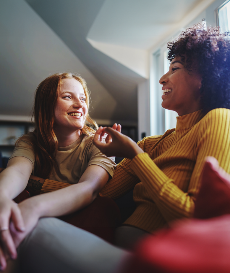 Young lesbian couple sitting on couch